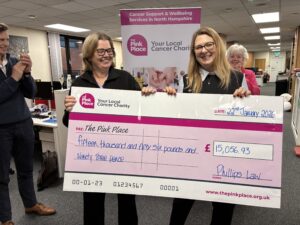 Kay Alsop and Trish Coutts hold the check while Jack Gardener and Christine Griffiths cheer tehm on.